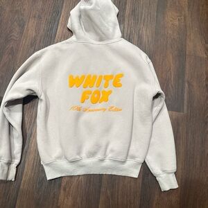 White Fox Boutique Cream Hoodie with Orange Text